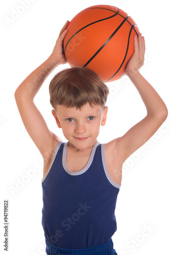Boy held a basketball ball over a head