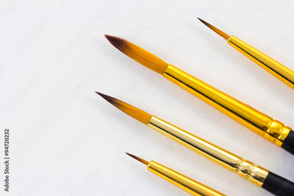 paintbrush on white paper background paintbrush on white paper background
