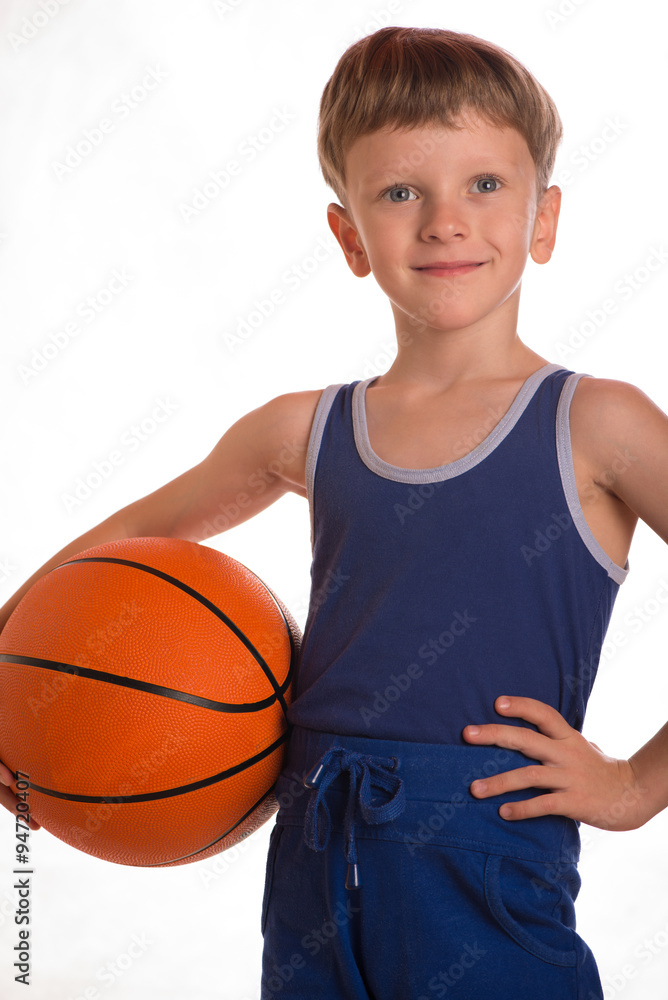 The boy held a basketball ball to a hip. The boy held a basketball ball to a hip.