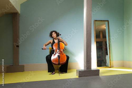 Leinwand Poster young girl playing cello