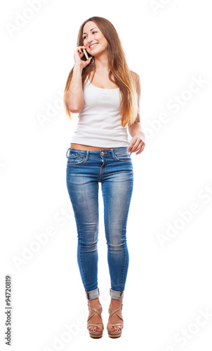 portrait of a pretty girl talking on telephone in a white background