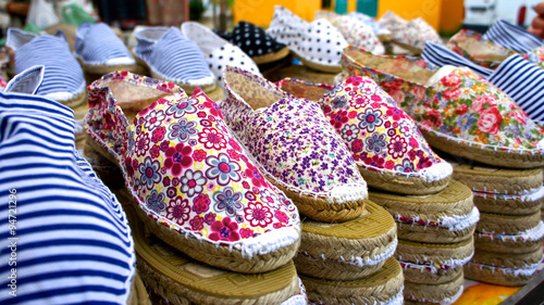 Artisan handmade shoes at market stall photo