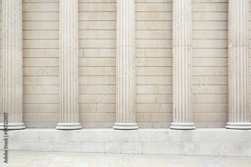 White classical columns and wall background with stone floor