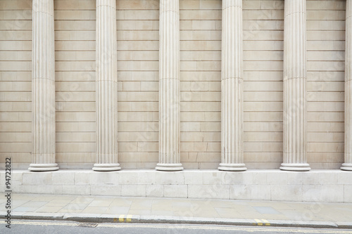 White classical columns and wall background with sidewalk floor