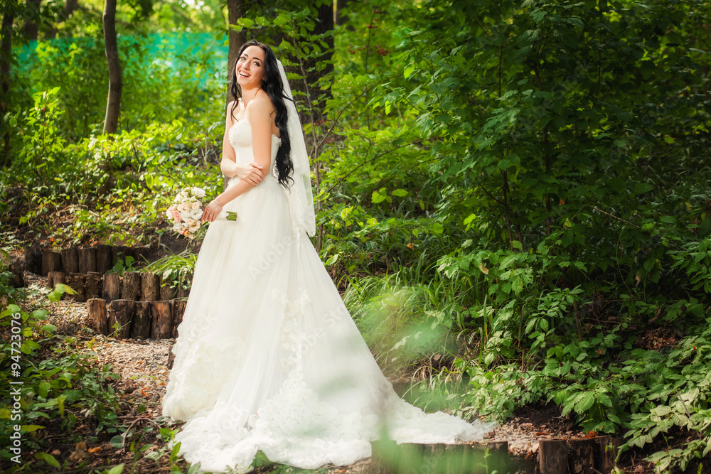 Bride in wedding dress in forest