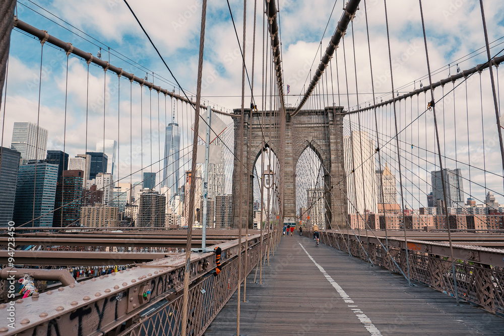 Naklejka premium Brooklyn Bridge w Nowym Jorku z pochmurnego nieba w czasie dnia.