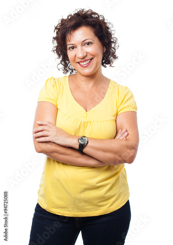 a mature woman standing with crossed arms