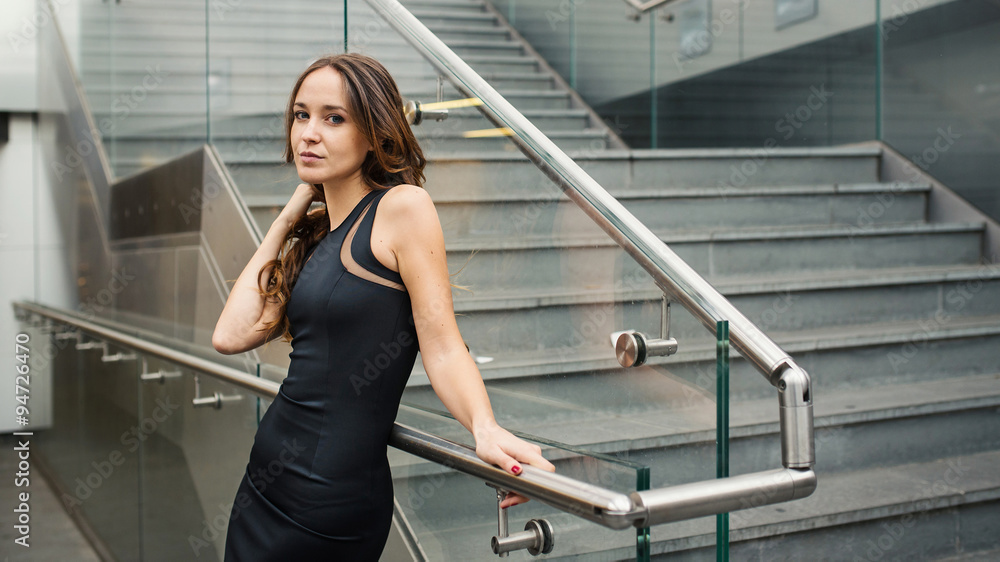 Fashion portrait of beautiful young woman in modern urban enviro