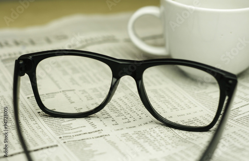 keyboard  a cup of coffee and a black eyeglasses on a financial