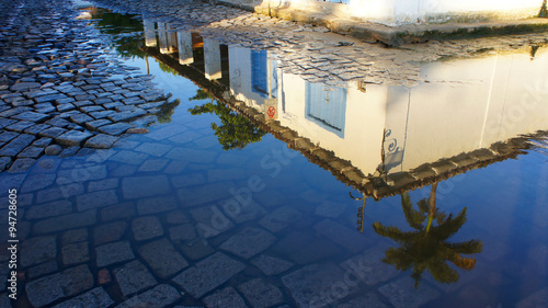 Reflection of a colonial house on a water puddle in Paraty, Brazil.