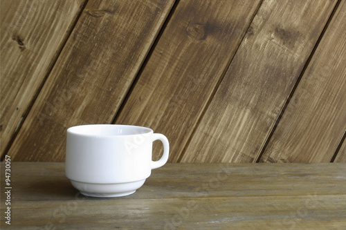 white cup on table on wooden background
