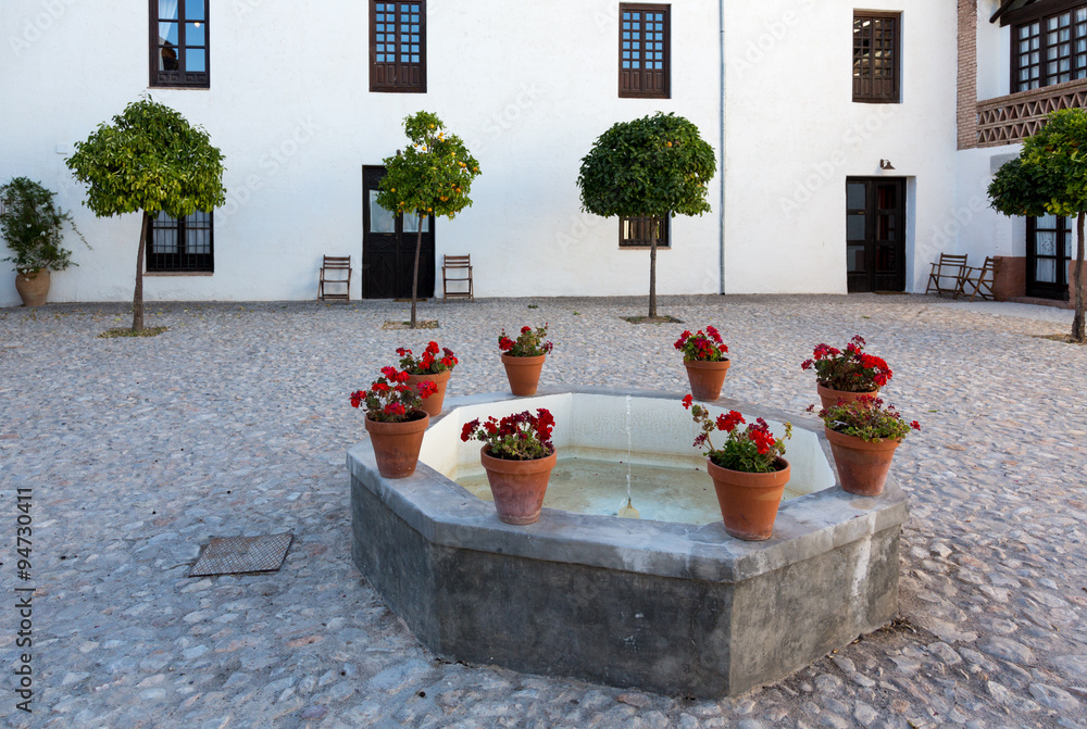 Warm courtyard with well or fountain in Spain