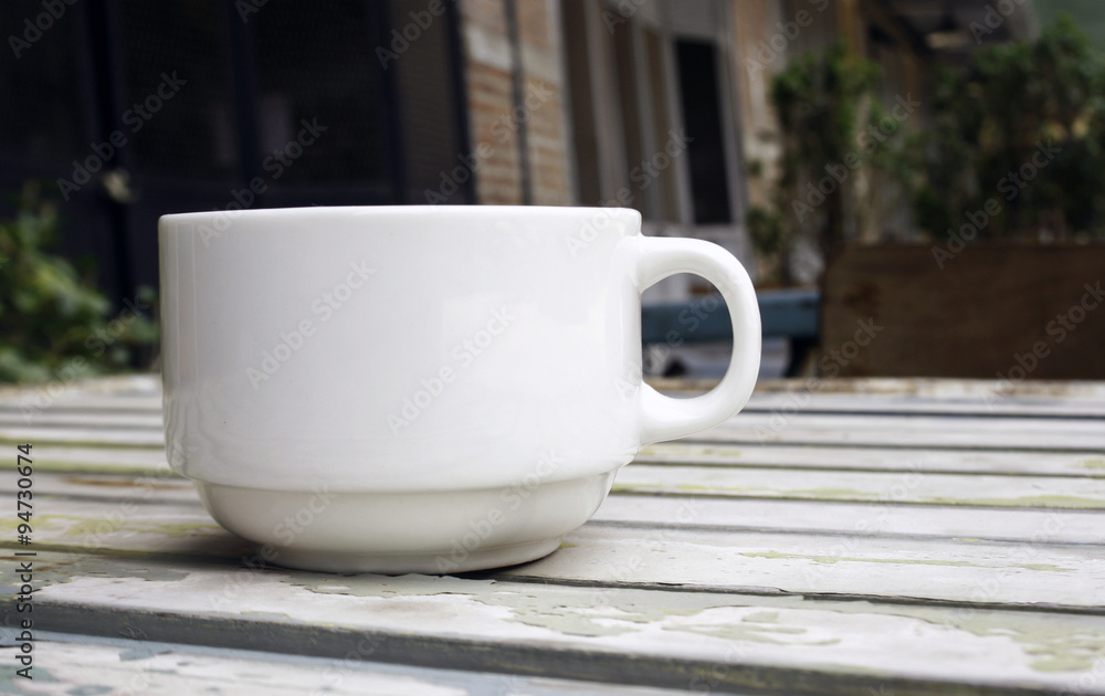 Coffee cup on wood table with blur background Coffee cup on wood table with blur background