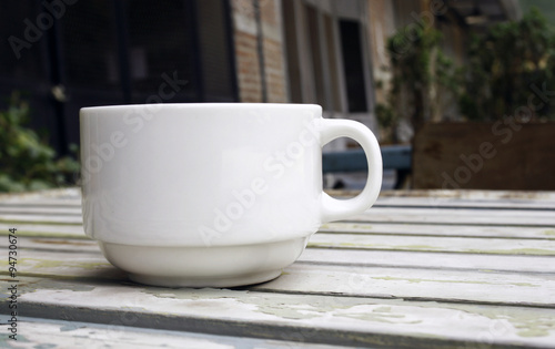 Coffee cup on wood table with blur background