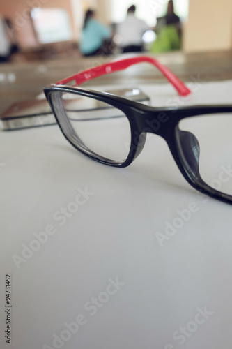 eye glasses placed on a blank paper sheet