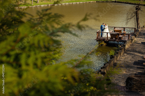 Bride and groom near big lake