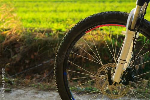 Beautiful close up scene of bicycle at sunset, © Aleksey