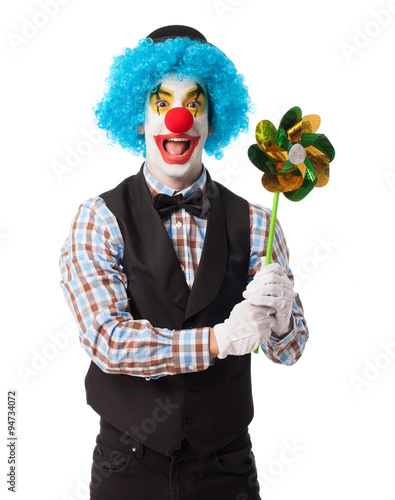 portrait of a funny clown holding a pinwheel