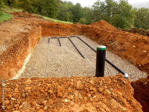 Bottom layer of pipework laid on gravel in the construction of a sand and gravel drainage system photo