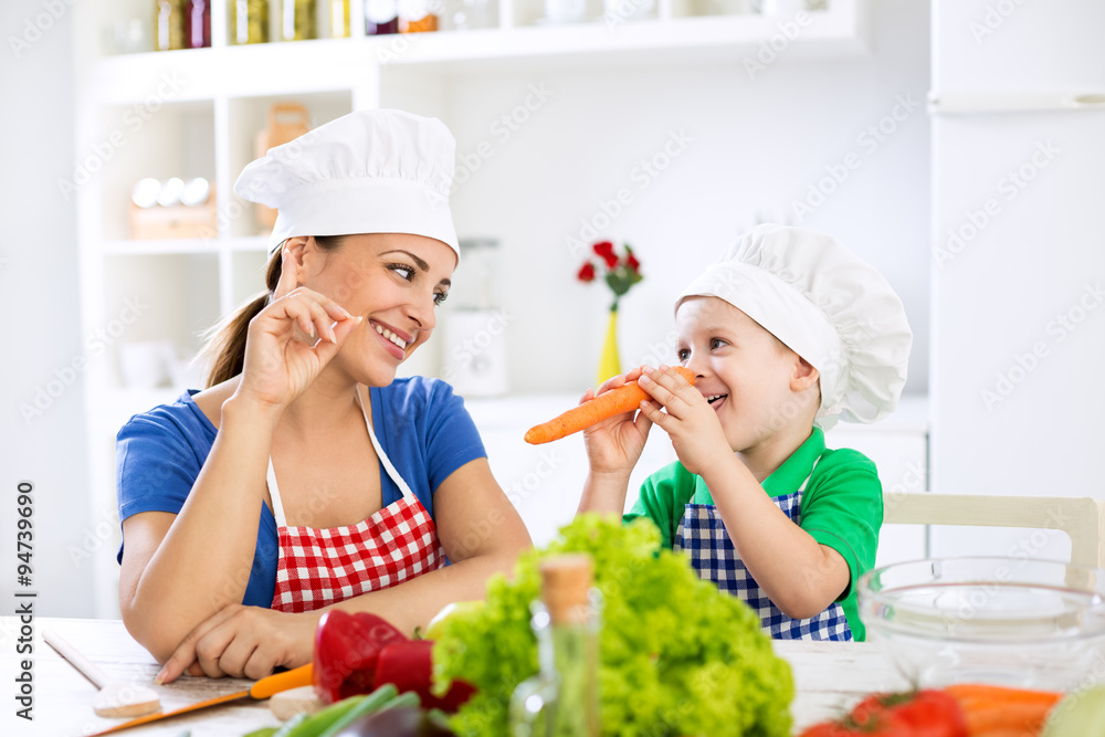 Beautiful attractive mother and child playing with vegetables Beautiful attractive mother and child playing with vegetables