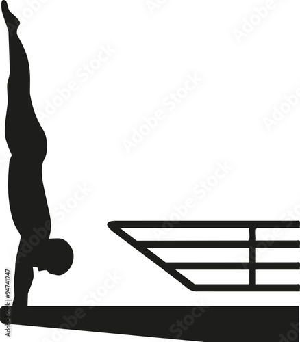 Silhouette of man at a high diving platform