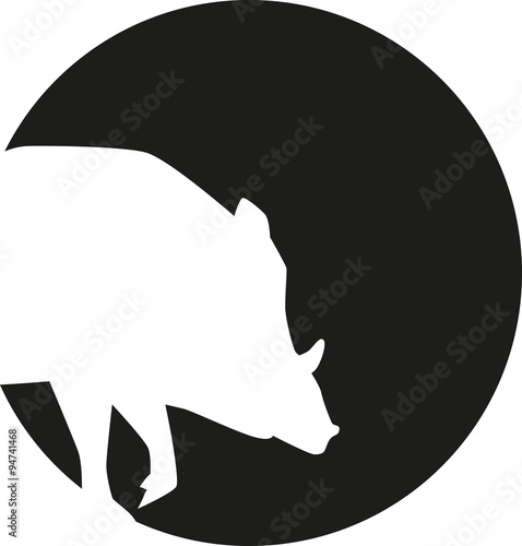 Wild pig silhouette in front of a moon