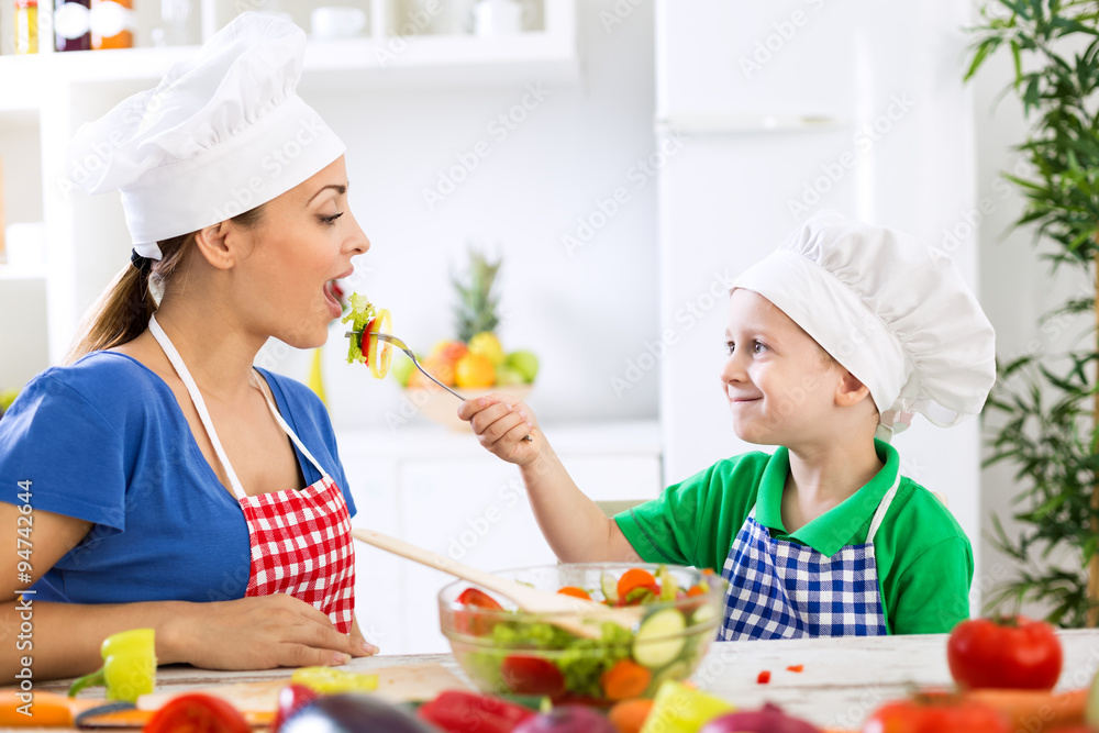 Child giving to his mother fresh healthy food Child giving to his mother fresh healthy food