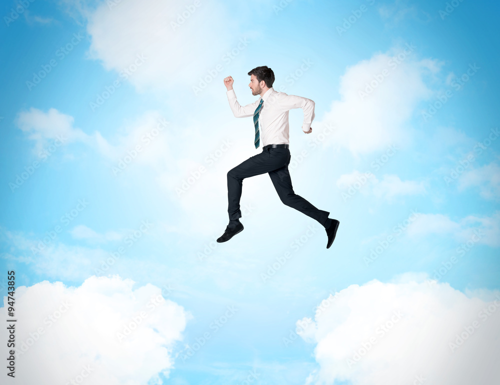Business person jumping over clouds in the sky Business person jumping over clouds in the sky
