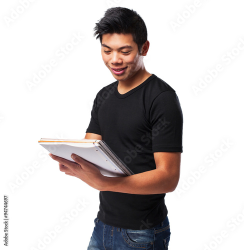 young chinese man holding his notebook