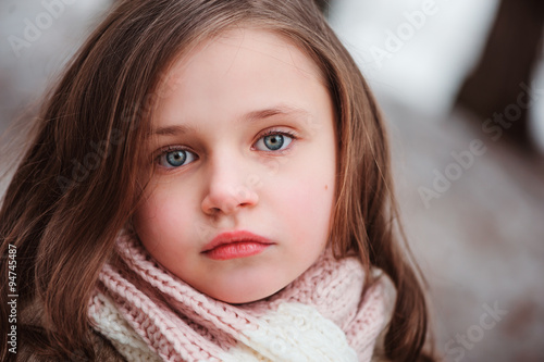 close up outdoor portrait of dreamy child girl in cozy scarf © mashiki