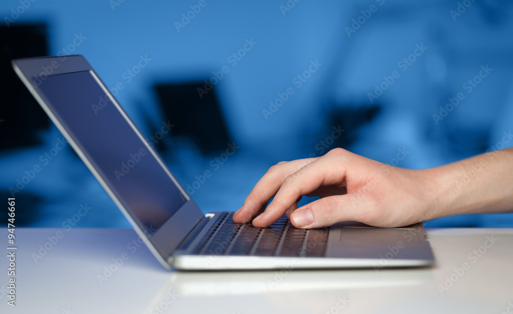 Businessman pressing modern laptop computer on colorful backgrou Businessman pressing modern laptop computer on colorful backgrou