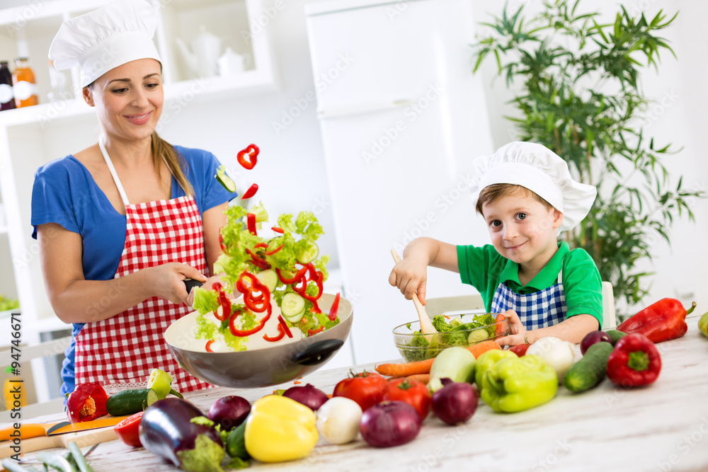 Beautiful happy smiling family cooking vegetables meal Beautiful happy smiling family cooking vegetables meal