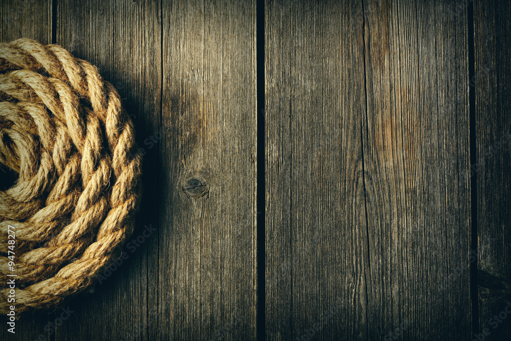 Fototapeta premium Rope over wooden background
