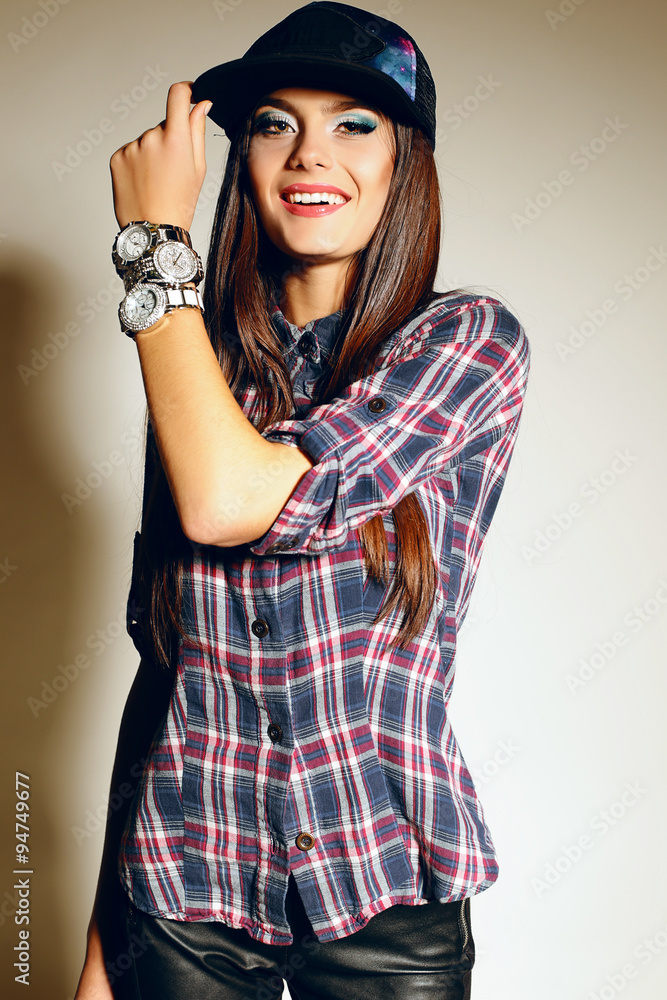 young woman with long dark hair wears casual plaid shirt and cap young woman with long dark hair wears casual plaid shirt and cap