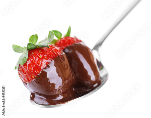 A fork and a couple of strawberries in chocolate isolated on white