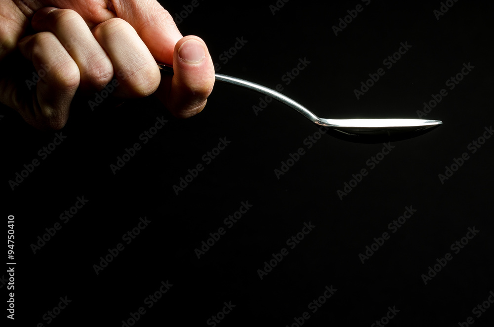 Hand holding an empty spoon