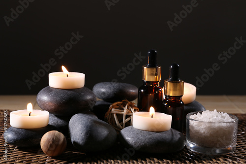 Beautiful spa composition on wicker napkin on dark background