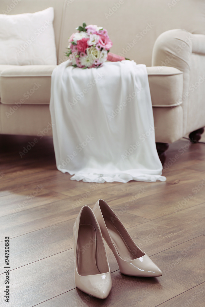 Wedding bouquet, bridesmaid dress and shoes in room Wedding bouquet, bridesmaid dress and shoes in room