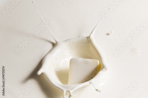 white chocolate falls in milk