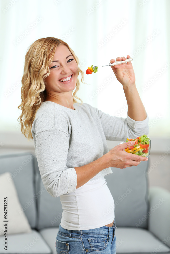 Beautiful woman with salad on home interior background Beautiful woman with salad on home interior background
