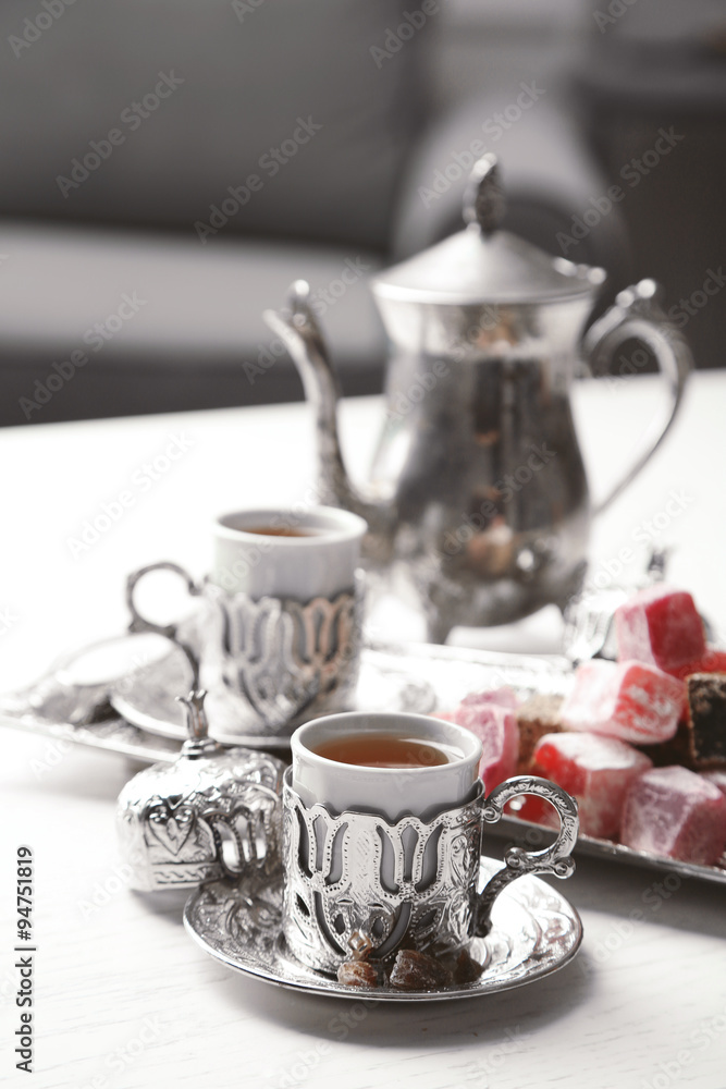 Antique tea-set with Turkish delight on table close-up