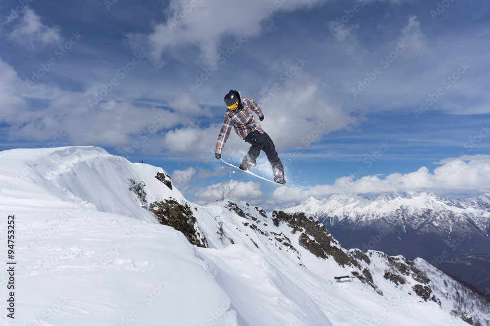 Flying snowboarder on mountains, extreme sport Flying snowboarder on mountains, extreme sport