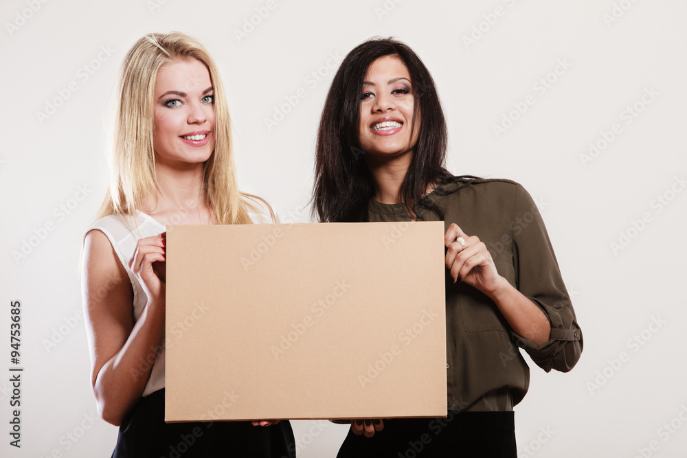 two women holding blank board