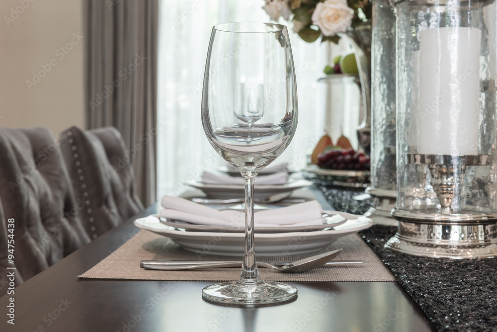 Fototapeta premium empty wine glass on wooden dinning table with table set
