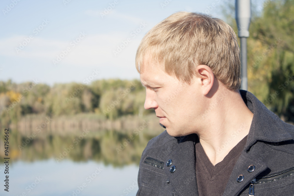 Pensive man on the bridge at the lake Pensive man on the bridge at the lake