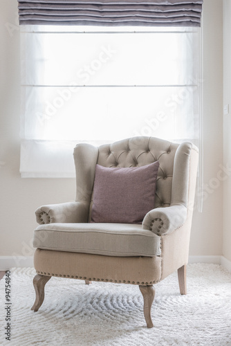 classic chair on carpet with pillow