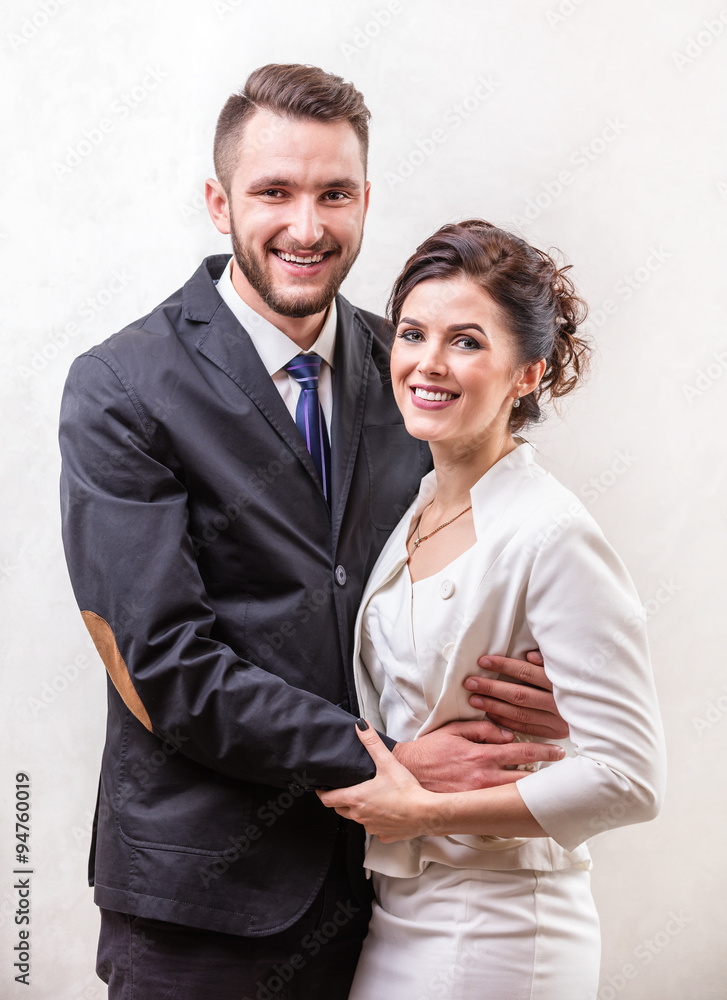 Cheerful young couple smiling over white Cheerful young couple smiling over white