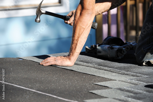 Obraz na plátně handyman working on repairing roof