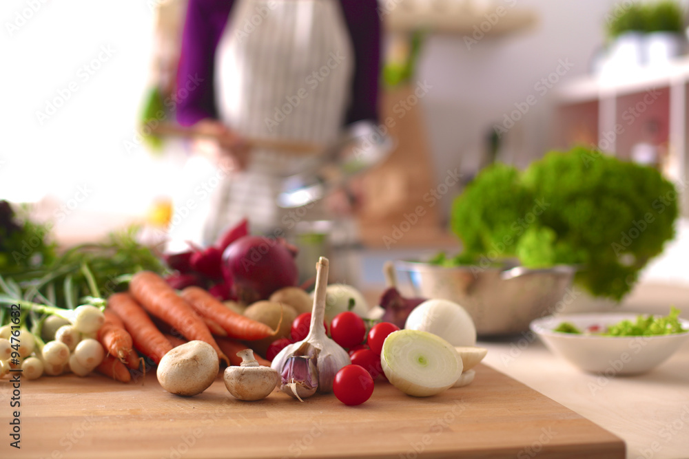 Pile of organic vegetables on a wooden table Pile of organic vegetables on a wooden table