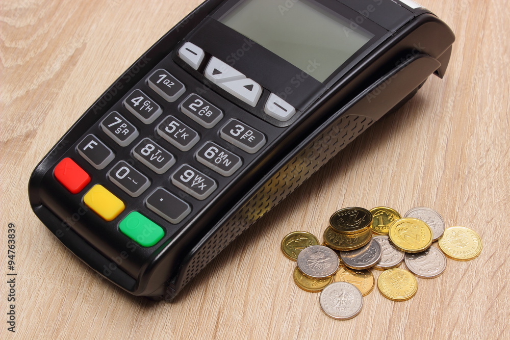 Payment terminal with polish currency, credit card machine on desk, finance concept Payment terminal with polish currency, credit card machine on desk, finance concept
